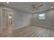Bedroom with wood-look flooring and access to bathroom at 3187 Galiot Rd, Venice, FL 34293