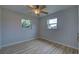 Bright bedroom with wood-look flooring and two windows at 3187 Galiot Rd, Venice, FL 34293