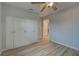 Bedroom with white closet doors and wood-look flooring at 3187 Galiot Rd, Venice, FL 34293