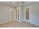 Guest bedroom with en-suite bathroom and wood-look floors at 3187 Galiot Rd, Venice, FL 34293
