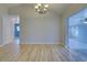 Bright dining room features light wood flooring and a modern chandelier at 3187 Galiot Rd, Venice, FL 34293