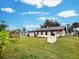 Back exterior view of house with a large backyard at 3187 Galiot Rd, Venice, FL 34293