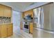 Modern kitchen with stainless steel appliances and wood cabinets at 3187 Galiot Rd, Venice, FL 34293