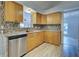 Modern kitchen with wood cabinets, granite counters and tile backsplash at 3187 Galiot Rd, Venice, FL 34293