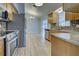 Open concept kitchen with stainless steel appliances and granite counters at 3187 Galiot Rd, Venice, FL 34293