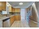 Modern kitchen with stainless steel appliances and wood cabinets at 3187 Galiot Rd, Venice, FL 34293