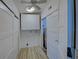 Laundry room with white cabinets and wood-look flooring at 3187 Galiot Rd, Venice, FL 34293