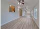 Bright living room with light wood floors and ceiling fans at 3187 Galiot Rd, Venice, FL 34293
