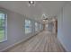 Open living area featuring light walls and wood-look floors at 3187 Galiot Rd, Venice, FL 34293