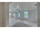 Sunlit living room with light wood flooring and large windows at 3187 Galiot Rd, Venice, FL 34293