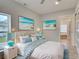 Main bedroom with beach decor and ensuite bathroom at 3187 Galiot Rd, Venice, FL 34293