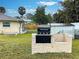 Built-in outdoor kitchen with a black grill at 3187 Galiot Rd, Venice, FL 34293