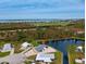 Aerial view of single-story home near water, showcasing waterfront location at 3300 Blue Jay Ln, Englewood, FL 34224