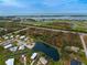 Aerial view showing a single-story home's peaceful waterfront setting at 3300 Blue Jay Ln, Englewood, FL 34224