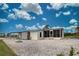 Home's backyard features gravel, firepit, and screened porch at 3300 Blue Jay Ln, Englewood, FL 34224