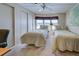 Guest bedroom with two twin beds and built-in closet at 3300 Blue Jay Ln, Englewood, FL 34224