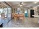 Bright dining room with built-in hutch and wood table, view to patio at 3300 Blue Jay Ln, Englewood, FL 34224
