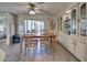 Charming dining area with built-in hutch and wood table, access to patio at 3300 Blue Jay Ln, Englewood, FL 34224