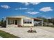 Single-wide mobile home with carport and landscaped yard at 3300 Blue Jay Ln, Englewood, FL 34224