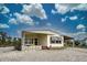 Single-wide mobile home with carport and landscaped yard at 3300 Blue Jay Ln, Englewood, FL 34224