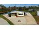 Single-wide mobile home with carport and firepit at 3300 Blue Jay Ln, Englewood, FL 34224