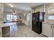 Galley kitchen with black appliances and ample cabinet space at 3300 Blue Jay Ln, Englewood, FL 34224