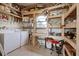 Laundry room with washer, dryer, and ample storage shelving at 3300 Blue Jay Ln, Englewood, FL 34224