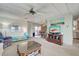 Spacious living room features comfy seating, large TV, and a view to the dining area at 3300 Blue Jay Ln, Englewood, FL 34224