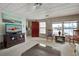 Bright living room with water views, comfy seating, and a large TV at 3300 Blue Jay Ln, Englewood, FL 34224