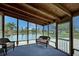 Screened porch overlooking a peaceful lake, perfect for relaxation at 3300 Blue Jay Ln, Englewood, FL 34224