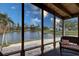 Serene screened porch with lake views, ideal for relaxation at 3300 Blue Jay Ln, Englewood, FL 34224