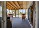 Bright screened porch with table and chairs overlooking nature at 3300 Blue Jay Ln, Englewood, FL 34224