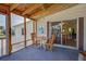 Screened porch with table and chairs, offering lake views at 3300 Blue Jay Ln, Englewood, FL 34224