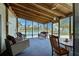 Spacious screened porch with wicker furniture and lake views at 3300 Blue Jay Ln, Englewood, FL 34224