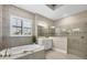 Bathroom with a walk-in shower, soaking tub, and neutral color palette at 400 Maraviya Blvd, Nokomis, FL 34275