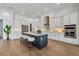 Modern kitchen with white cabinets, large island, and stainless steel appliances at 400 Maraviya Blvd, Nokomis, FL 34275