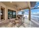 Outdoor kitchen area with seating and a built-in grill overlooking the lake at 400 Maraviya Blvd, Nokomis, FL 34275