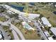 Aerial view of condo complex showcasing the pool, building location, and surrounding golf course at 408 Cerromar S Cir # 132, Venice, FL 34293