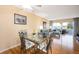 Dining area with glass table, metal chairs, and a view of the living room and patio at 408 Cerromar S Cir # 132, Venice, FL 34293