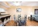 Dining area with glass table and metal chairs, view into kitchen and living room at 408 Cerromar S Cir # 132, Venice, FL 34293