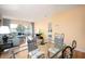 Bright dining area with glass-top table and metal chairs, open to living room at 408 Cerromar S Cir # 132, Venice, FL 34293