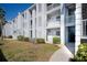 Exterior view of condo building, showing walkway, landscaping, and building facade at 408 Cerromar S Cir # 132, Venice, FL 34293