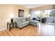 Living room with light walls, sectional sofa, and sliding glass doors leading to a patio at 408 Cerromar S Cir # 132, Venice, FL 34293
