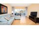 Living room with sectional sofa, sliding glass doors, and a flat-screen TV at 408 Cerromar S Cir # 132, Venice, FL 34293
