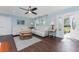 Open living room with white couches, wood floors, and access to front porch at 4129 Coleman Rd, Venice, FL 34293