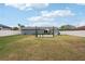 Large backyard with gray house and patio at 4310 Albacore Cir, Port Charlotte, FL 33948