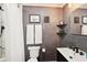 Modern bathroom with gray textured walls and floating shelves at 4310 Albacore Cir, Port Charlotte, FL 33948