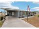 Gray house with carport and American flag at 4310 Albacore Cir, Port Charlotte, FL 33948