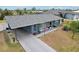 Gray house with landscaped yard, driveway, and American flag at 4310 Albacore Cir, Port Charlotte, FL 33948