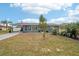 Gray house with landscaped yard, driveway, and American flag at 4310 Albacore Cir, Port Charlotte, FL 33948